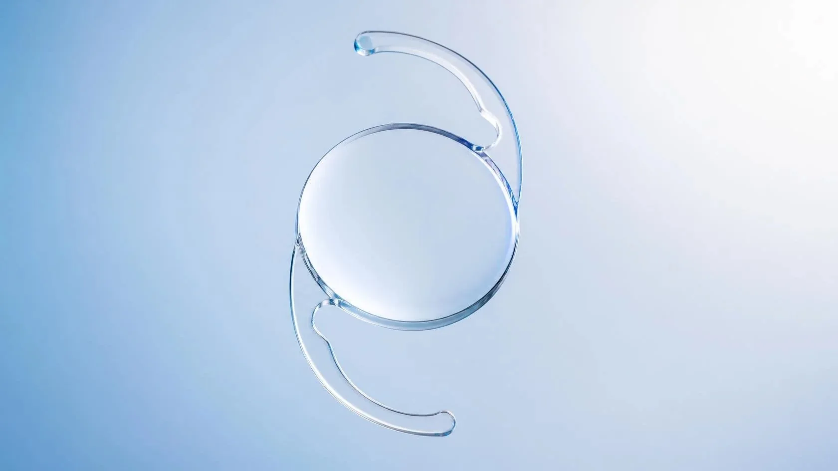 A clear artificial intraocular lens with two thin curved supports