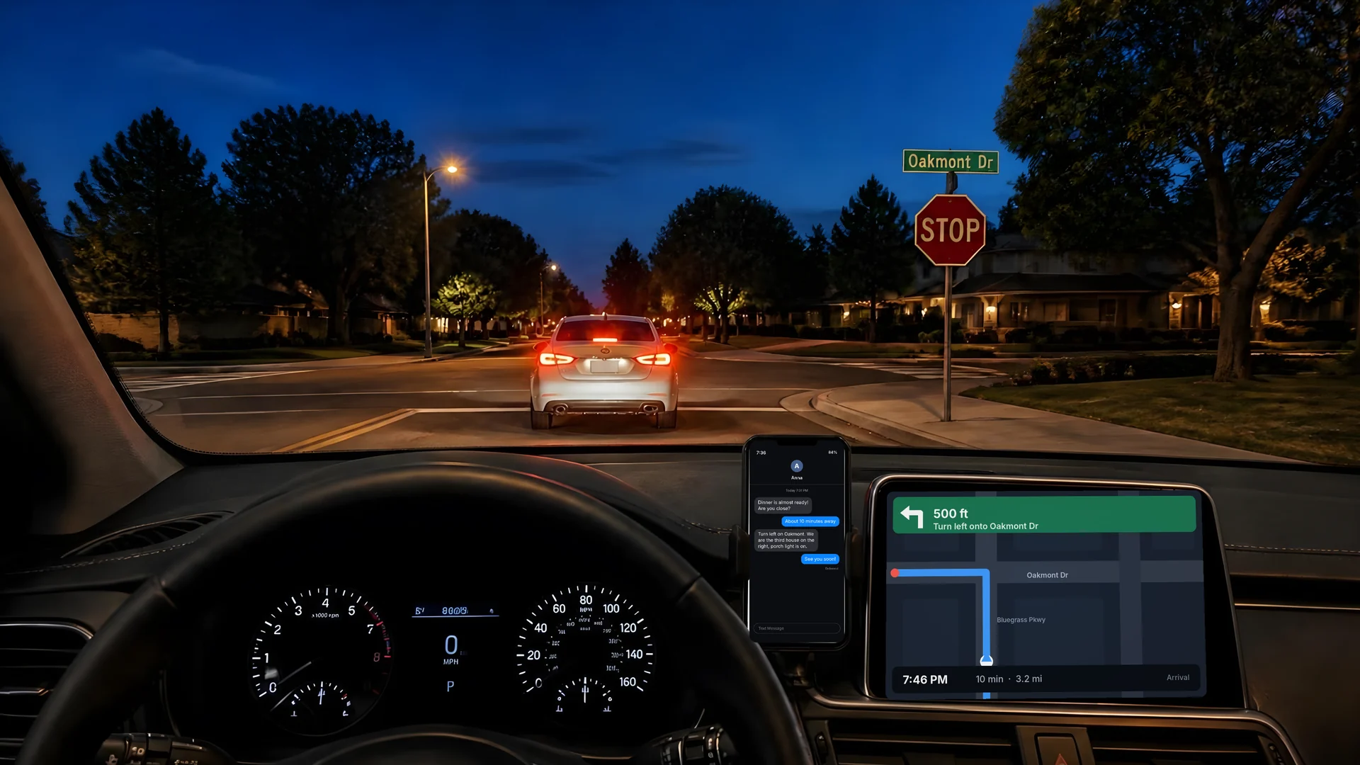 Driving at dusk seen through the selected lens: a stop sign and tail lights ahead, the dashboard navigation screen and a phone in a dash mount